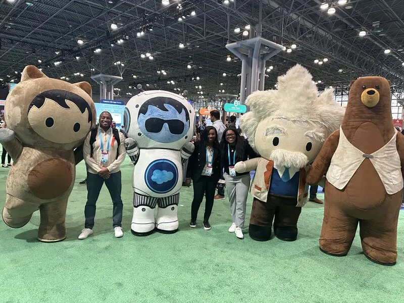 Life-size Astro and Salesforce character costumes with attendees at an event