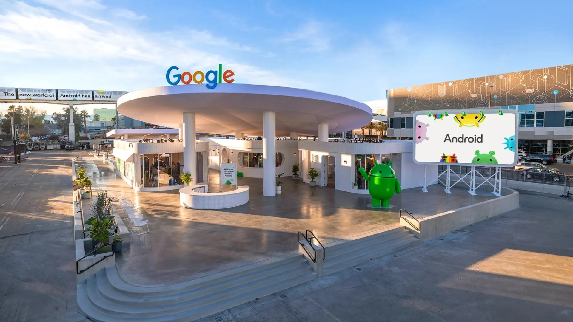 A large green Android Bot standing beside Google's Android experience at CES 2024