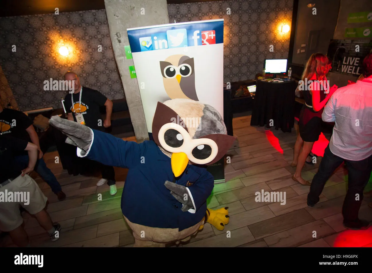 A large Owly mascot greeting attendees at a technology event