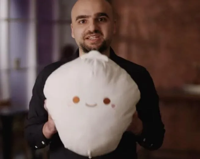 Bun creator Jarred Sumner holding an oversized Bun mascot plush